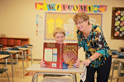 Teacher assisting student in personal finance class