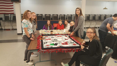 Members work on fleece blankets